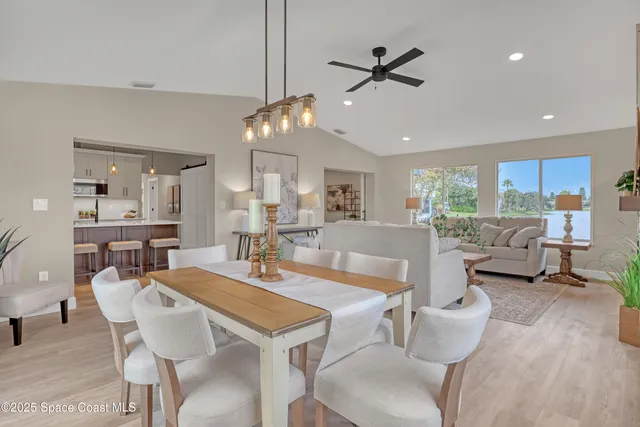 a kitchen with a table chairs stove and cabinets