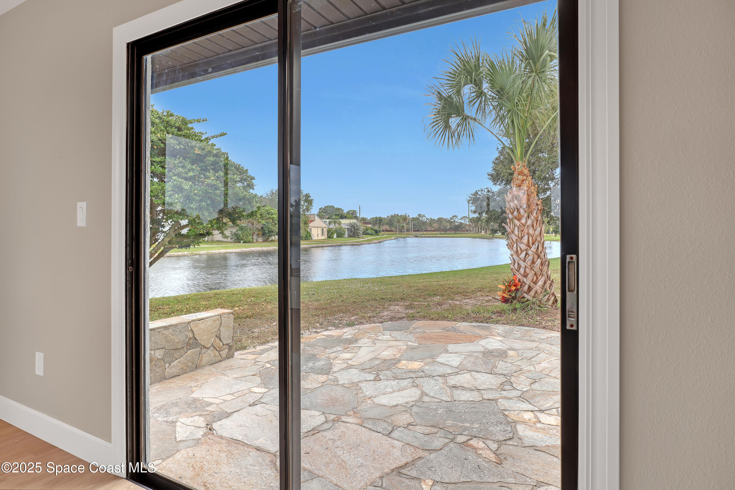 443 Myrtlewood Road Melbourne, FL 32940 - Photo 20 of 72 a view of a floor to ceiling window and a yard