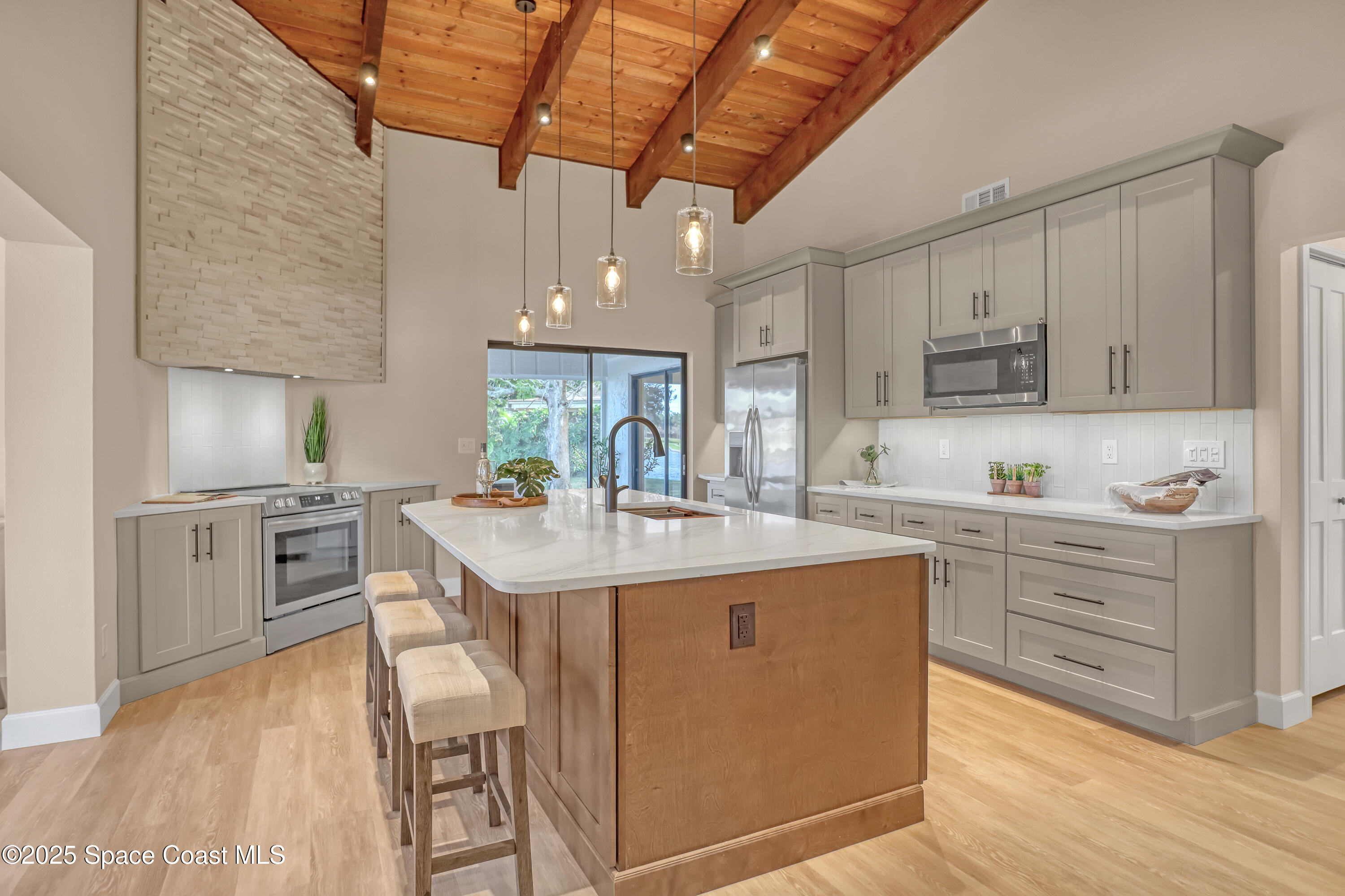 443 Myrtlewood Road Melbourne, FL 32940 - Photo 21 of 72 a kitchen with granite countertop a sink appliances cabinets and furniture