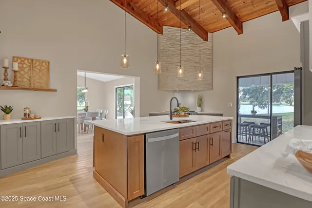 a kitchen with stainless steel appliances a refrigerator sink and microwave