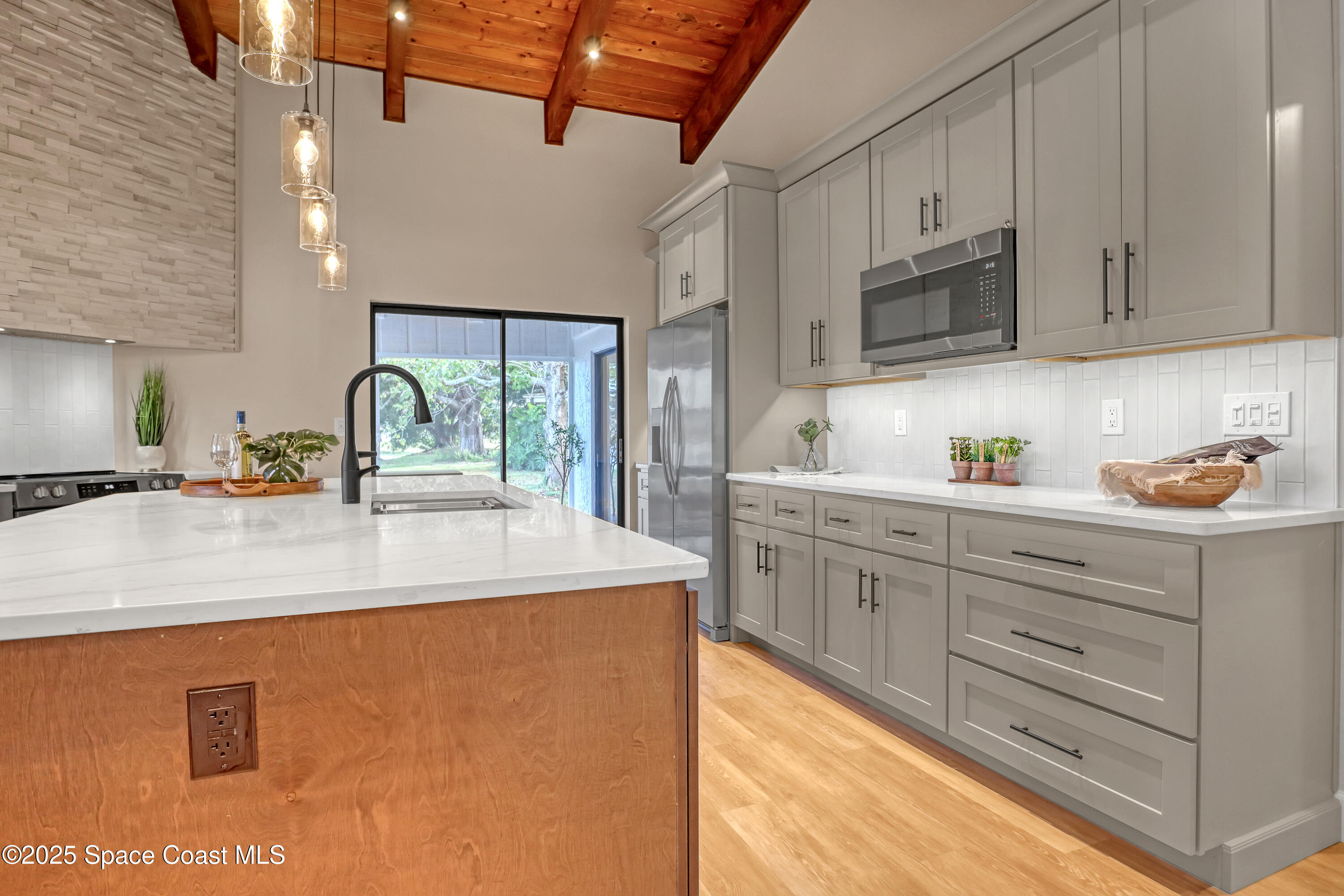 443 Myrtlewood Road Melbourne, FL 32940 - Photo 25 of 72 a kitchen with stainless steel appliances granite countertop a sink a stove and a refrigerator