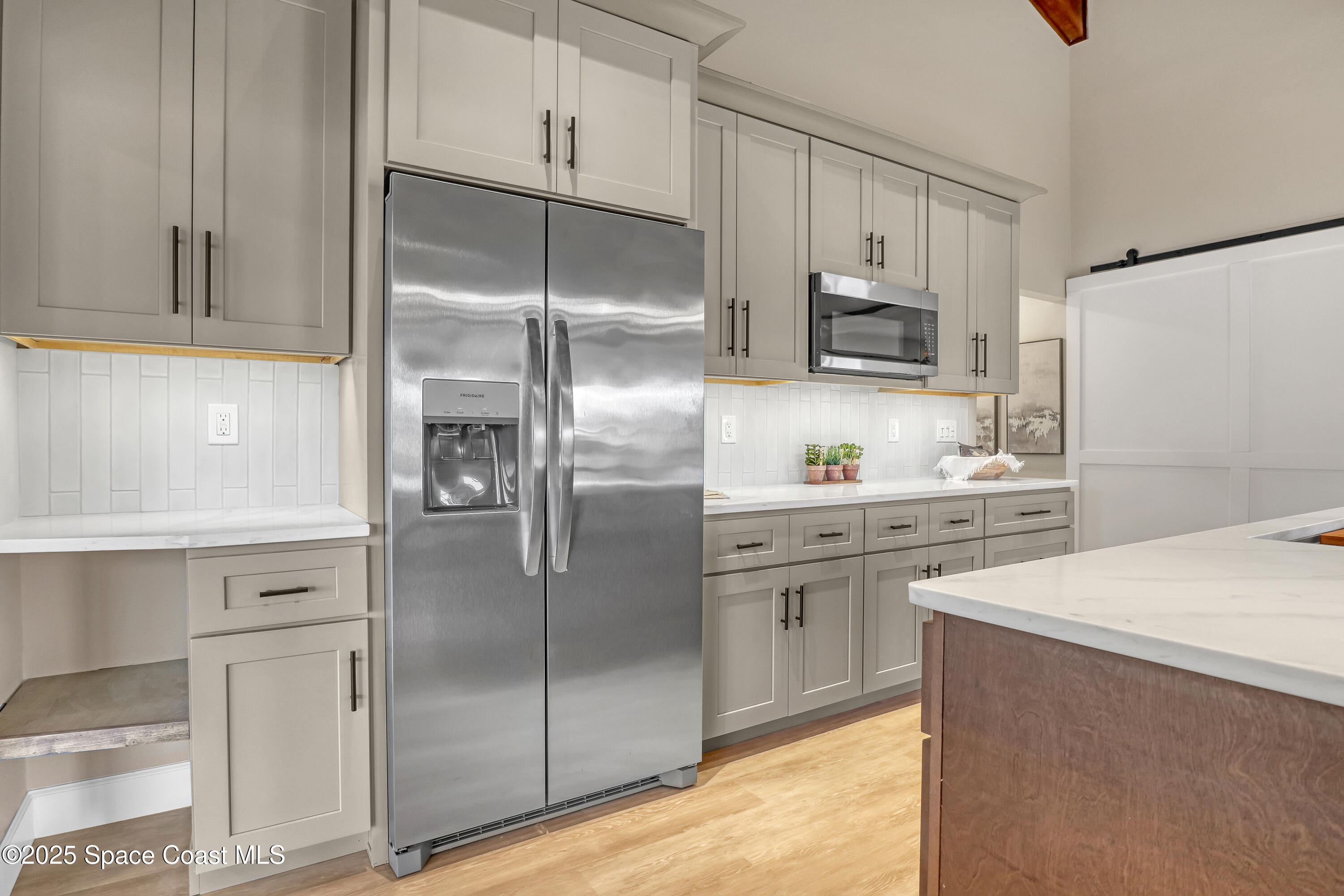 443 Myrtlewood Road Melbourne, FL 32940 - Photo 26 of 72 a kitchen with stainless steel appliances a refrigerator sink and cabinets