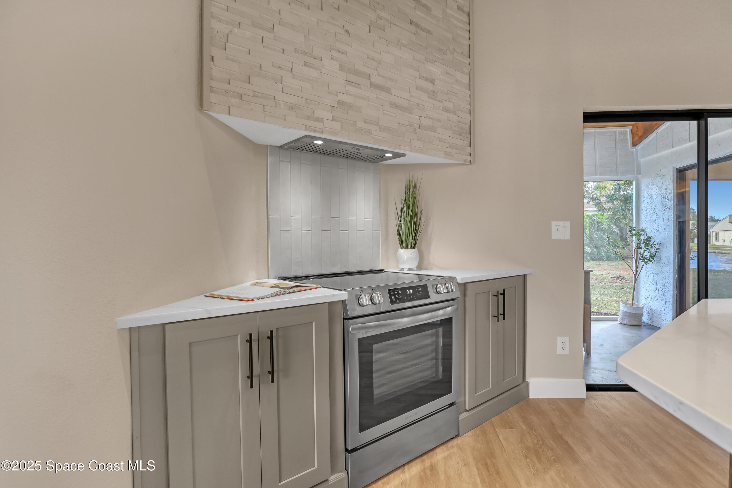 443 Myrtlewood Road Melbourne, FL 32940 - Photo 29 of 72 a kitchen with a stove and a sink