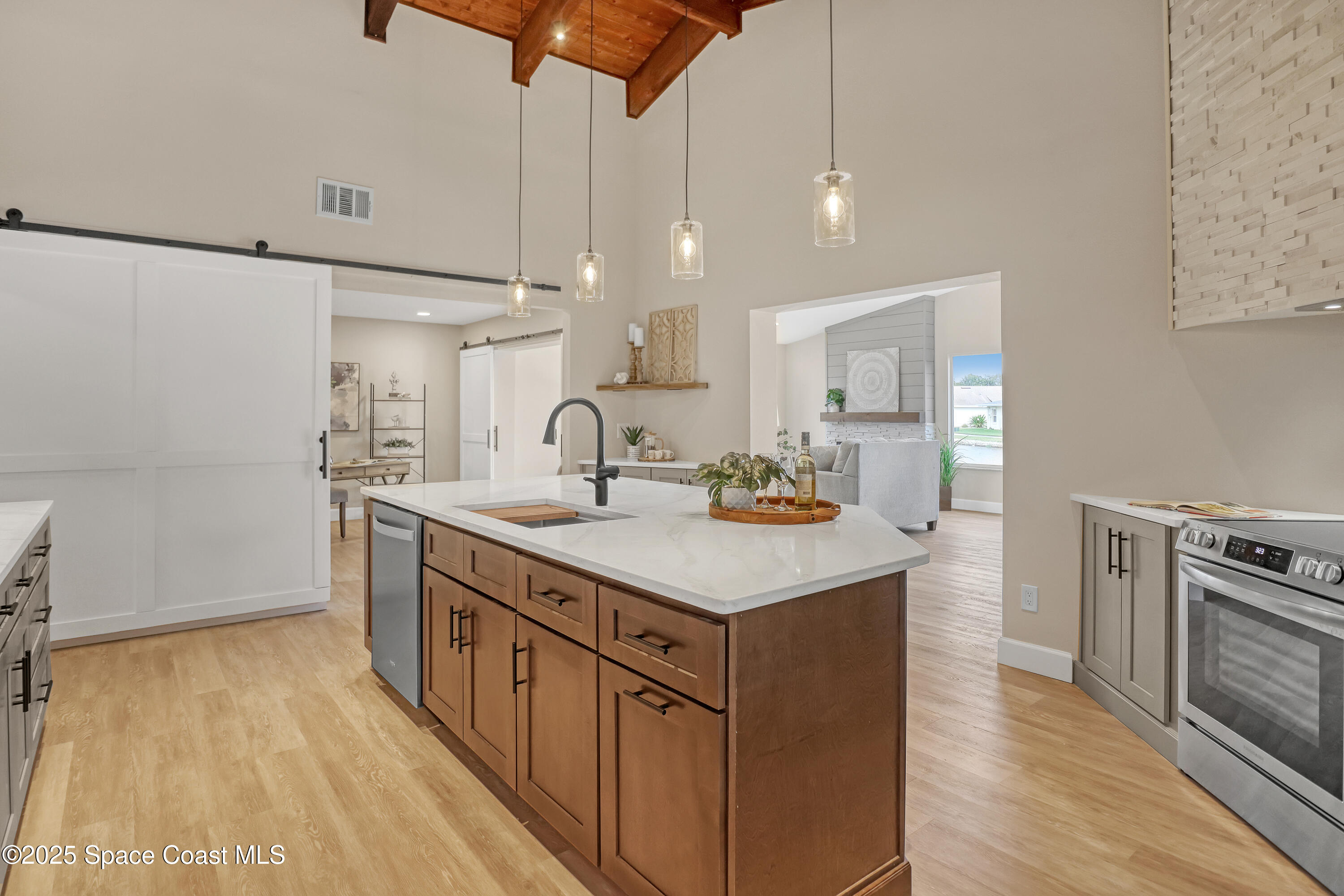 443 Myrtlewood Road Melbourne, FL 32940 - Photo 32 of 72 a kitchen with kitchen island a sink appliances and cabinets