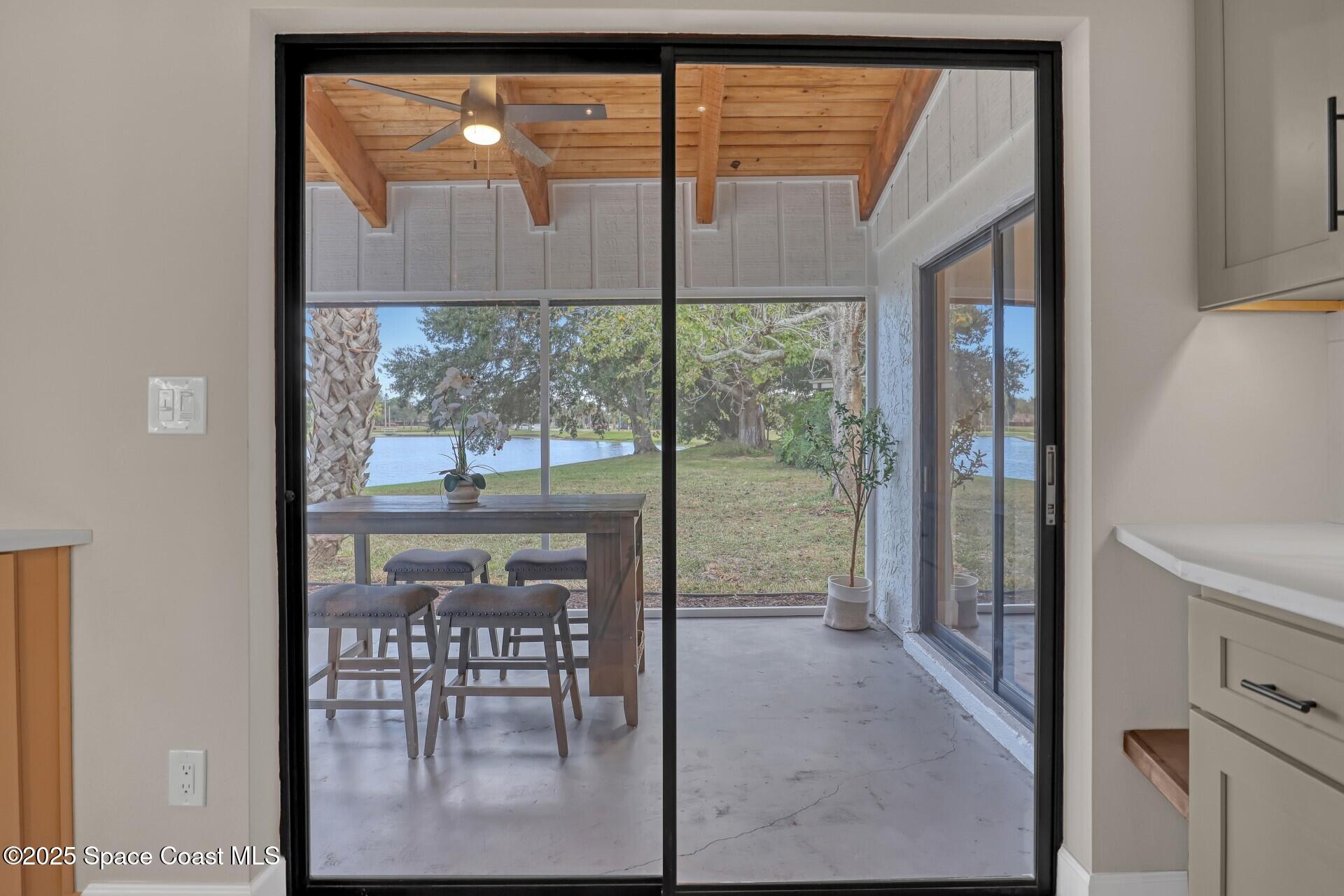 443 Myrtlewood Road Melbourne, FL 32940 - Photo 34 of 72 a view of a room with a floor to ceiling window and a table