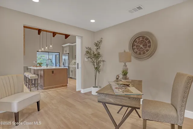 an empty room with wooden floor and window