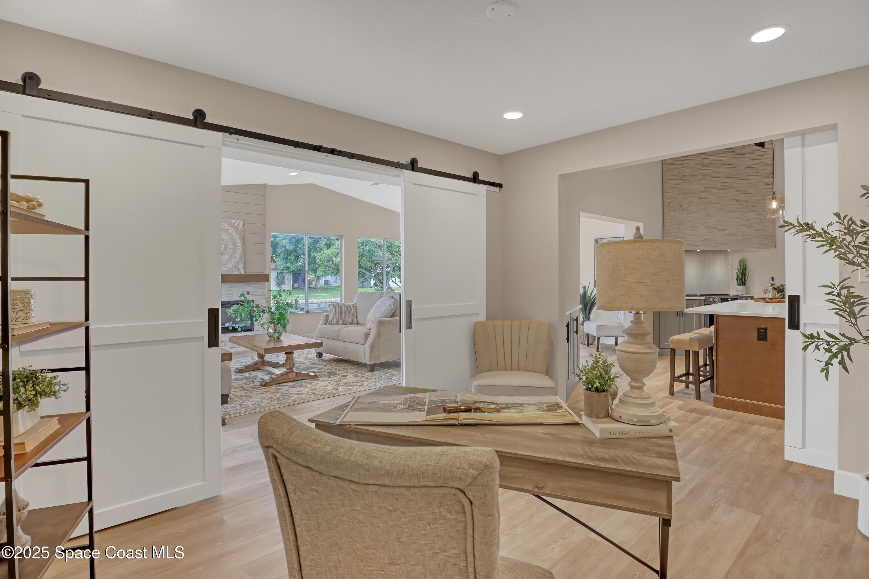 443 Myrtlewood Road Melbourne, FL 32940 - Photo 38 of 72 a living room with kitchen island furniture and a fireplace