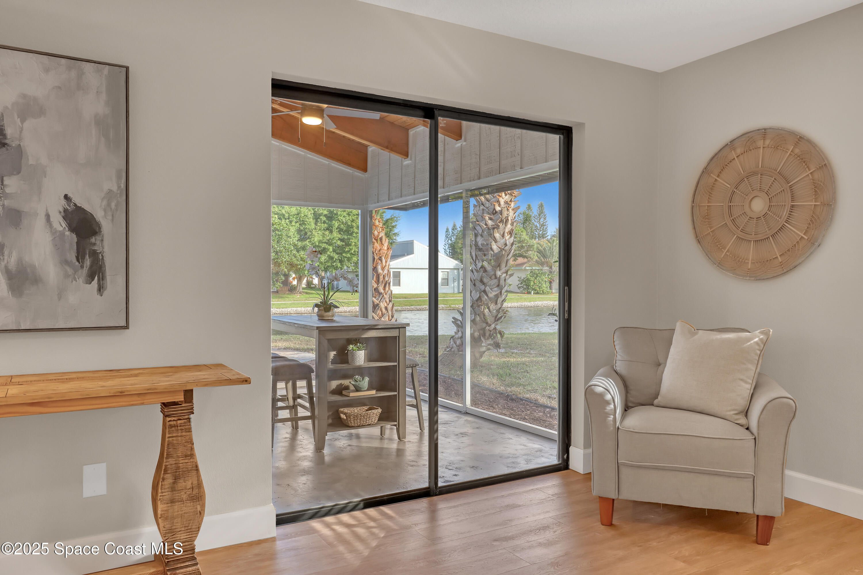 443 Myrtlewood Road Melbourne, FL 32940 - Photo 43 of 72 a living room with furniture and a floor to ceiling window