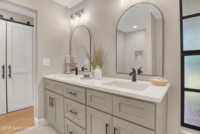 a front view of house with yard and trees all around