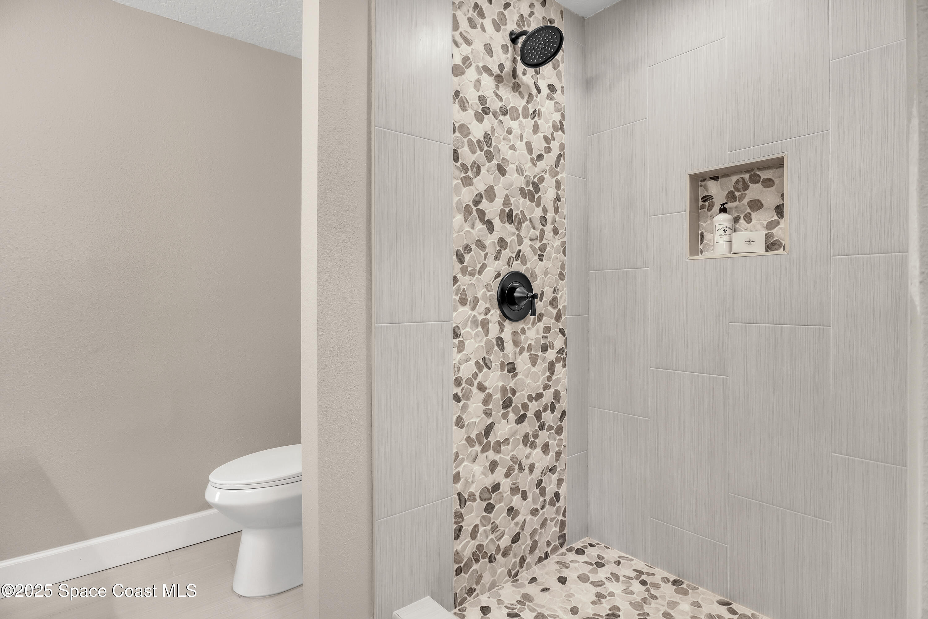 443 Myrtlewood Road Melbourne, FL 32940 - Photo 47 of 72 a bathroom with a toilet and a shower curtain