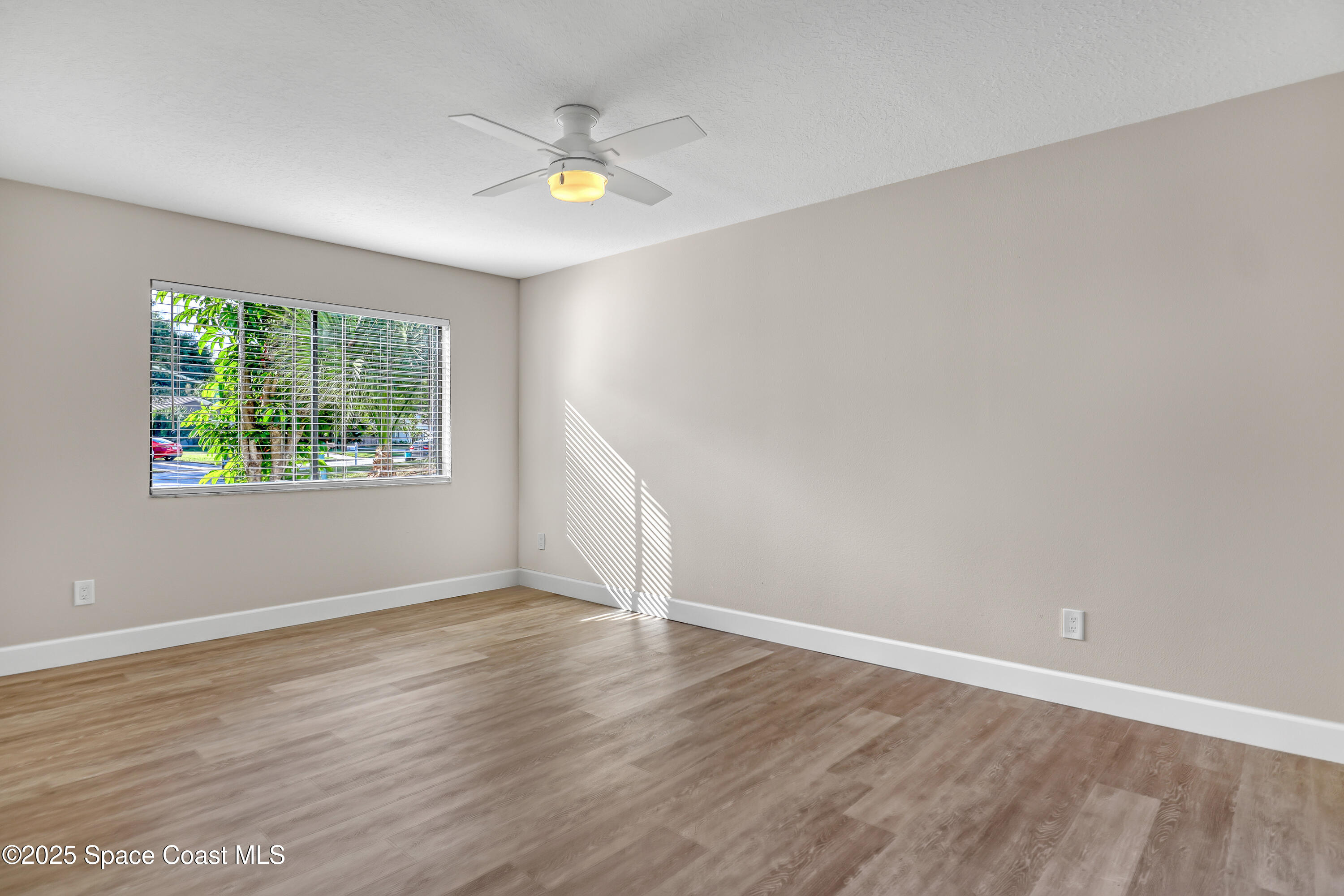 443 Myrtlewood Road Melbourne, FL 32940 - Photo 48 of 72 an empty room with wooden floor and window