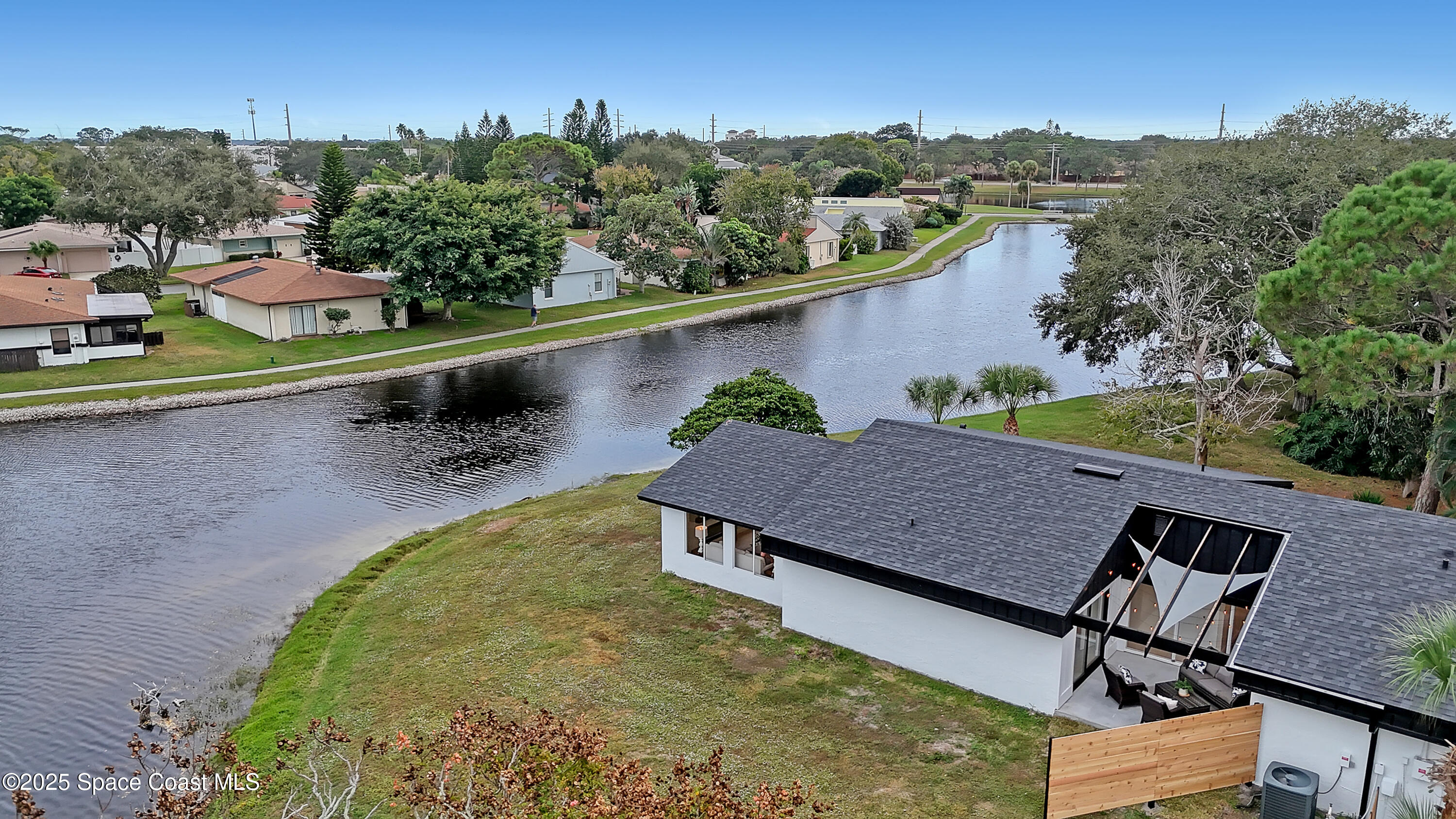443 Myrtlewood Road Melbourne, FL 32940 - Photo 5 of 72 an aerial view of a house with a yard and lake view