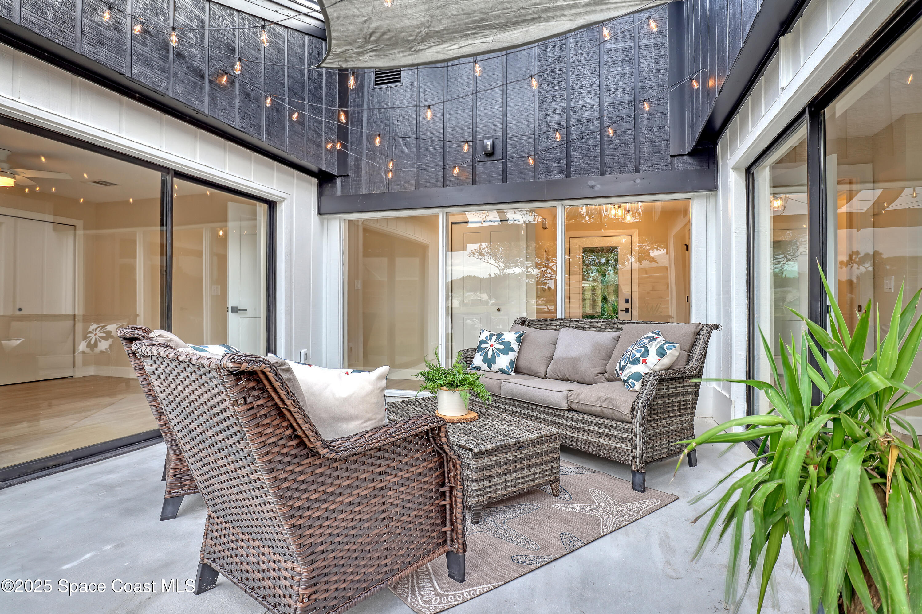443 Myrtlewood Road Melbourne, FL 32940 - Photo 57 of 72 a living room with furniture and a large window