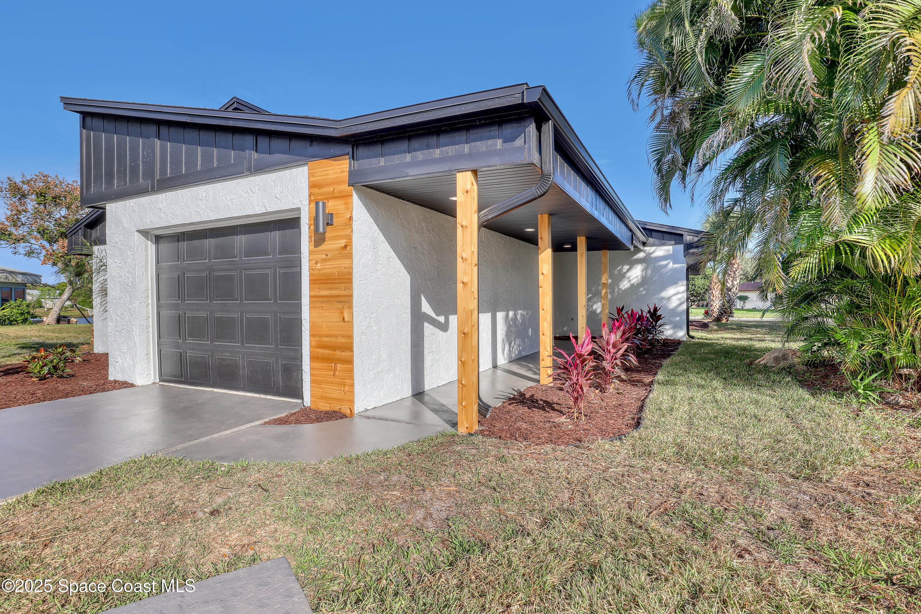 443 Myrtlewood Road Melbourne, FL 32940 - Photo 7 of 72 a view of a house with a patio