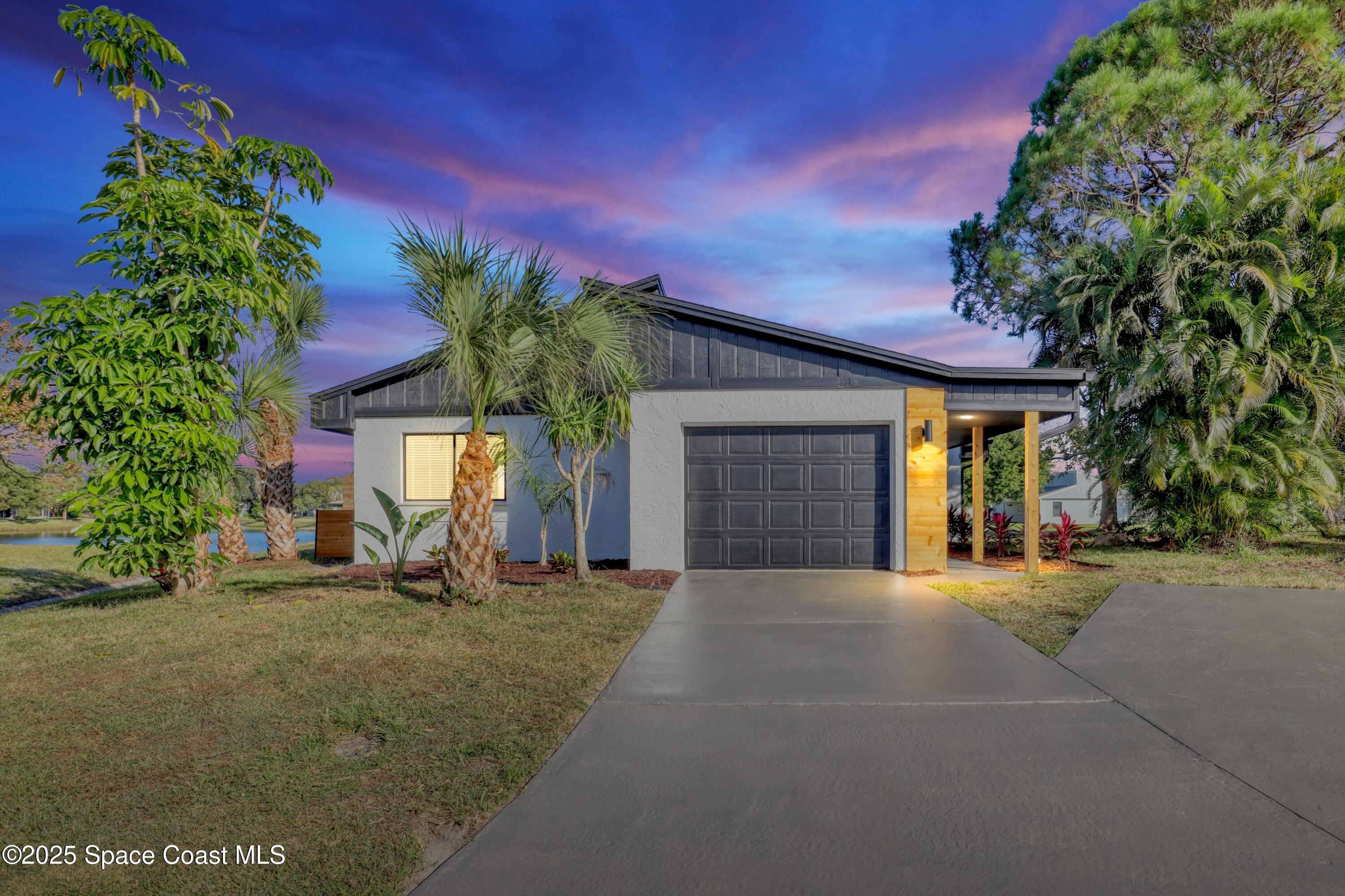 443 Myrtlewood Road Melbourne, FL 32940 - Photo 8 of 72 a front view of a house with a yard and garage