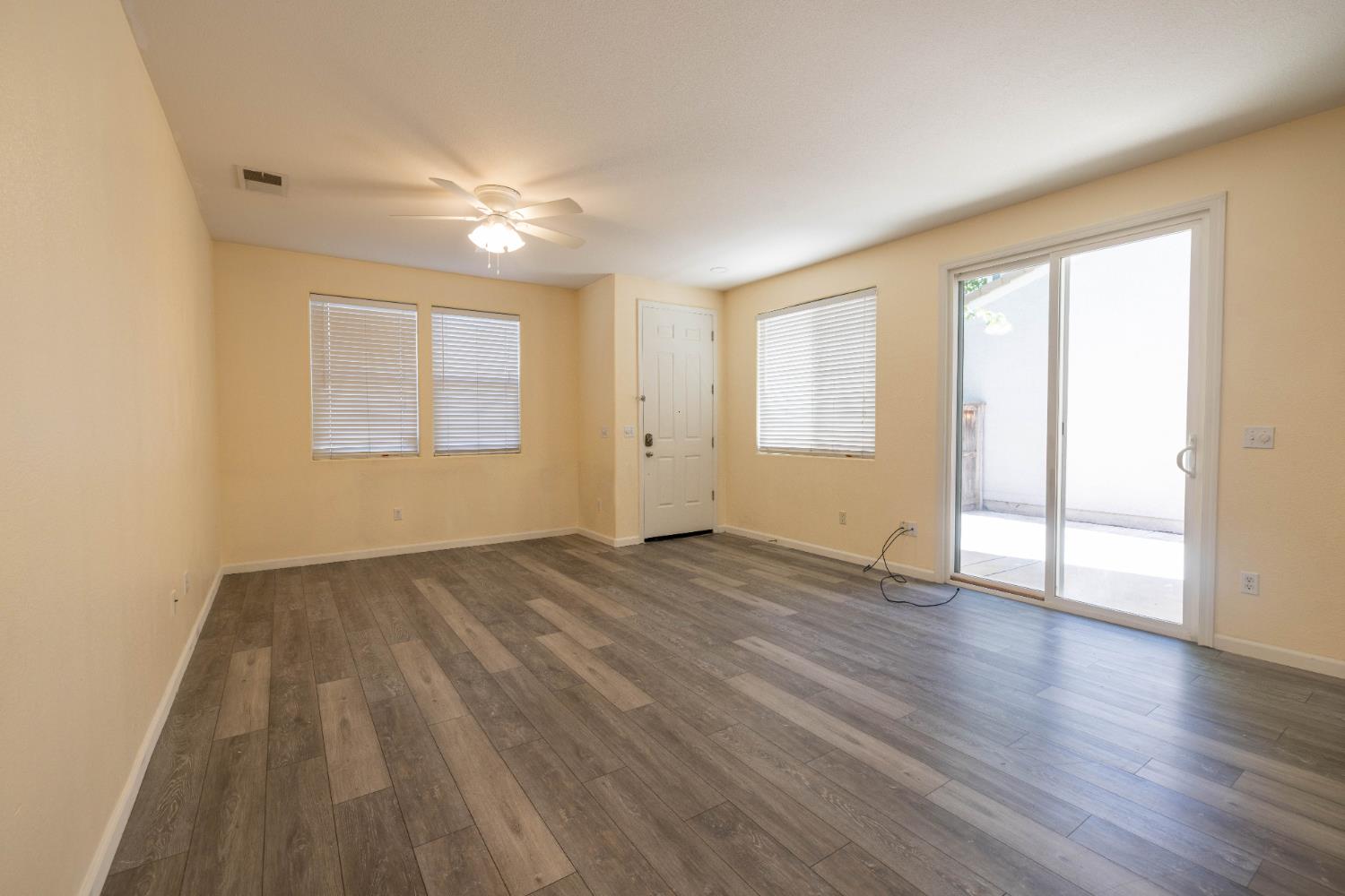 3122 Lea Sterling Way Rancho Cordova, CA 95670 - Photo 3 of 31 an empty room with wooden floor and windows