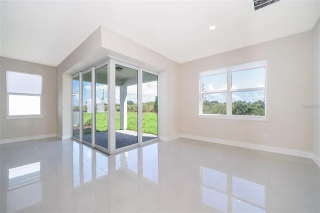 an empty room with floor to ceiling windows and walls