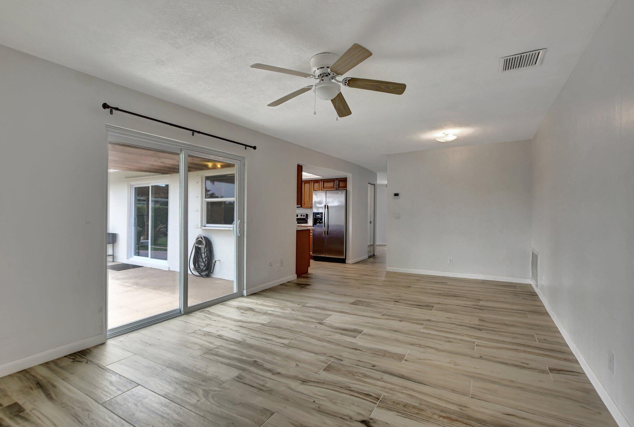 254 Northwest 11th Avenue Boca Raton, FL 33486 - Photo 23 of 66 a view of a livingroom with wooden floor and a ceiling fan