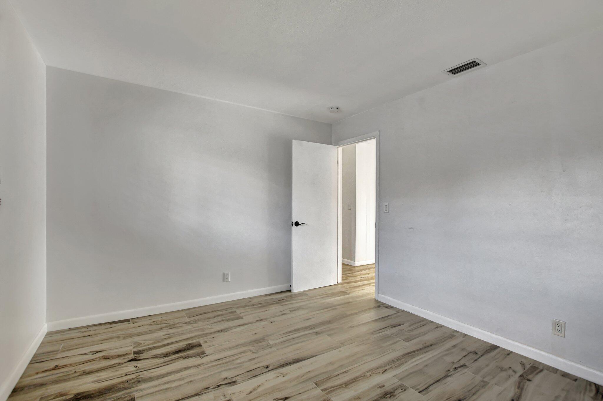 254 Northwest 11th Avenue Boca Raton, FL 33486 - Photo 35 of 66 a view of an empty room with wooden floor