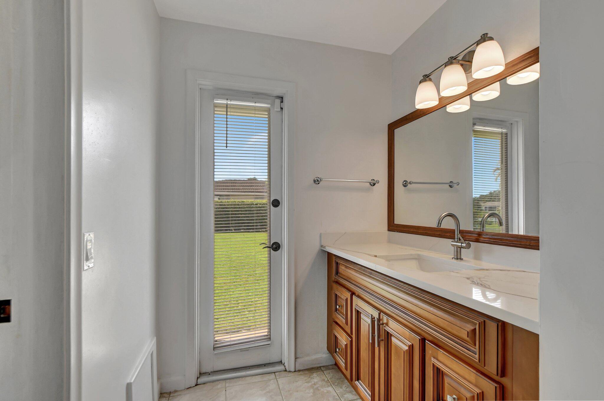 254 Northwest 11th Avenue Boca Raton, FL 33486 - Photo 39 of 66 a bathroom with a sink and a mirror