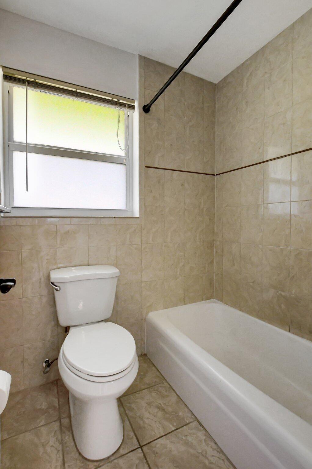 254 Northwest 11th Avenue Boca Raton, FL 33486 - Photo 41 of 66 a bathroom with a toilet a sink and a bathtub