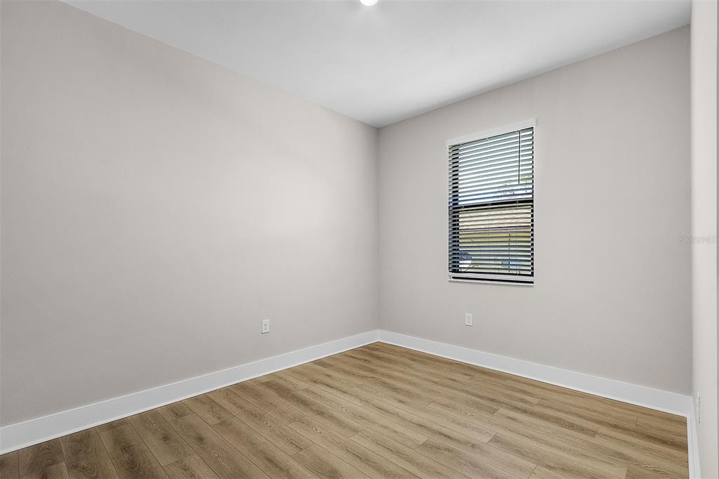 13515 Walden Sheffield Road Dover, FL 33527 - Photo 2 of 7 a view of an empty room with wooden floor and a window