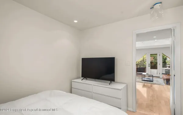 a living room with a flat screen tv and a white wall