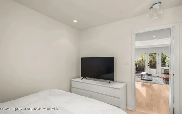 a living room with a flat screen tv and a white wall