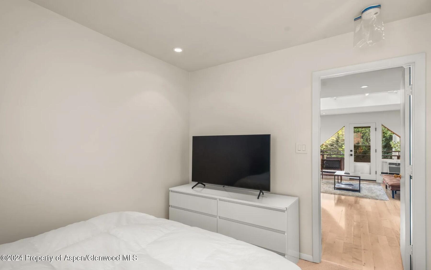 108 West Hyman Avenue, Unit 2 Aspen, CO 81611 - Photo 12 of 18 a living room with a flat screen tv and a white wall