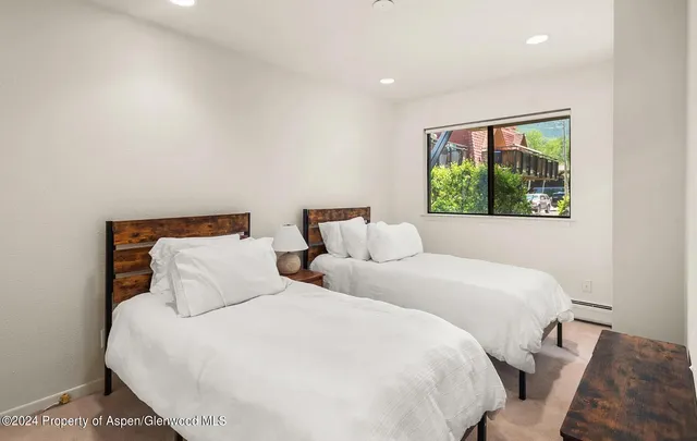 a bedroom with double bed and a window