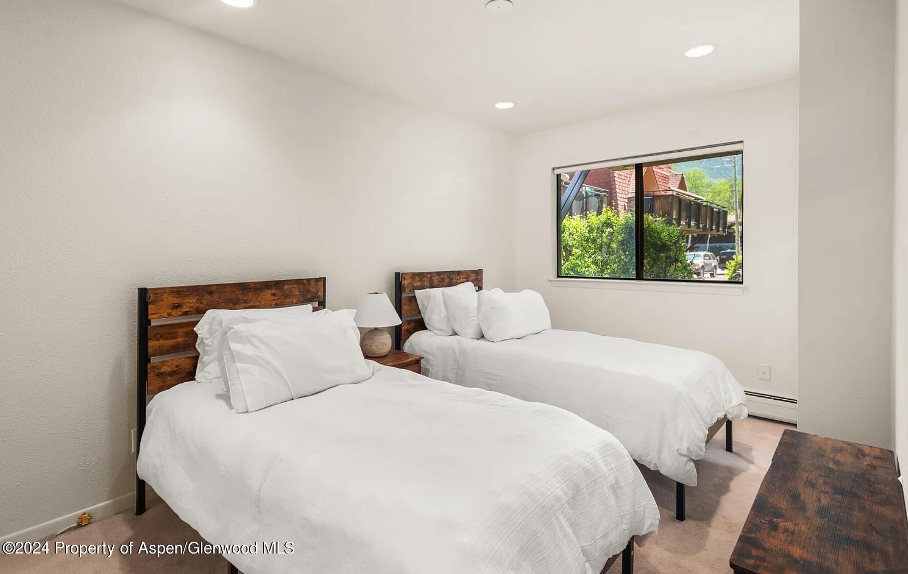 108 West Hyman Avenue, Unit 2 Aspen, CO 81611 - Photo 14 of 18 a bedroom with double bed and a window