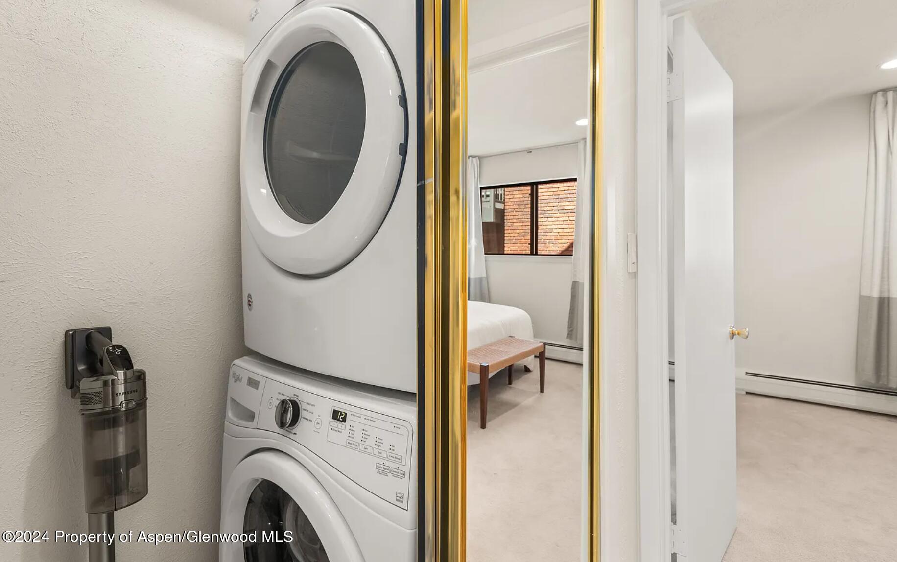 108 West Hyman Avenue, Unit 2 Aspen, CO 81611 - Photo 15 of 18 a view of a bedroom with washer and dryer