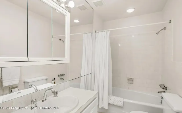 a bathroom with a tub sink and a shower