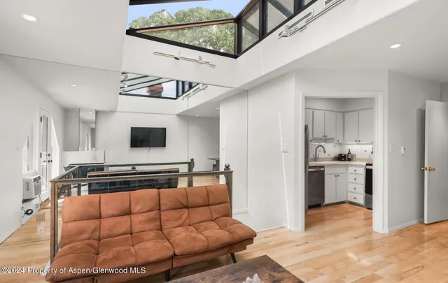 a living room with furniture and flat screen tv