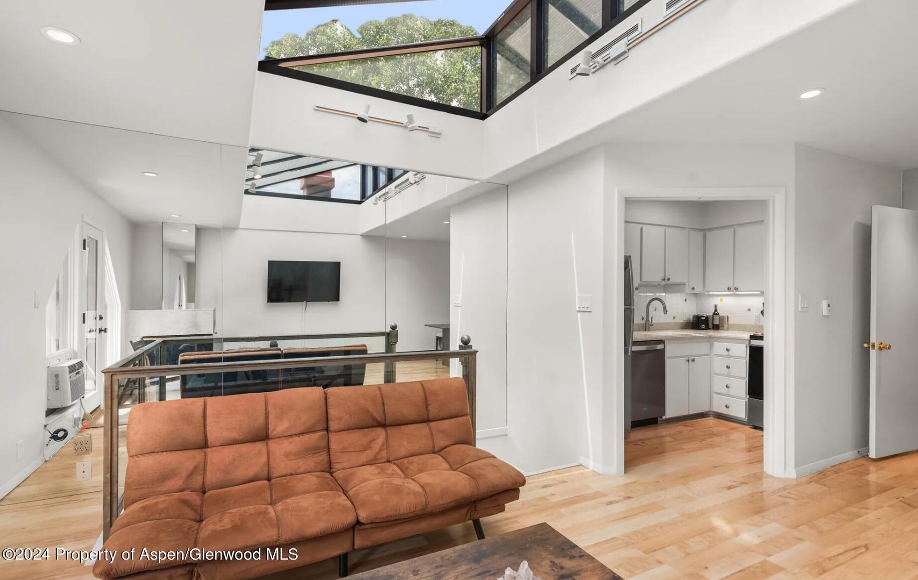 108 West Hyman Avenue, Unit 2 Aspen, CO 81611 - Photo 5 of 18 a living room with furniture and flat screen tv