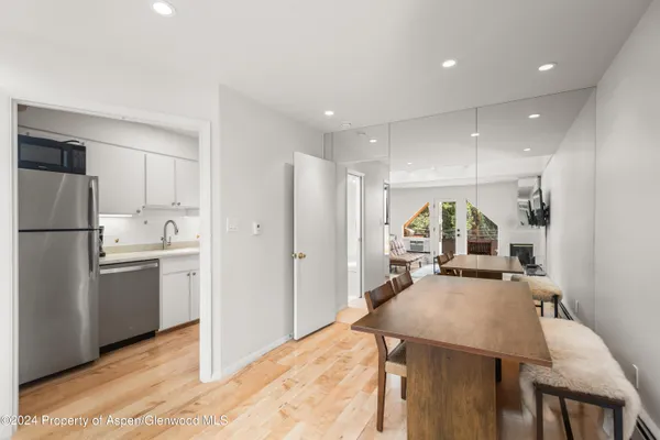 a kitchen with refrigerator and cabinets