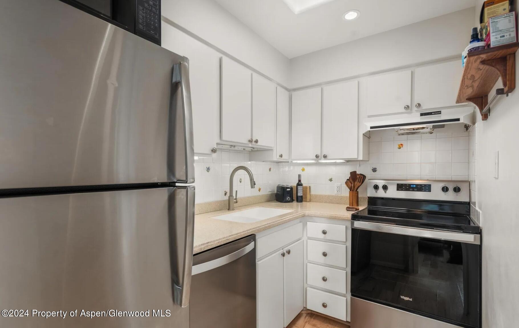 108 West Hyman Avenue, Unit 2 Aspen, CO 81611 - Photo 10 of 18 a kitchen with a white cabinets and white appliances