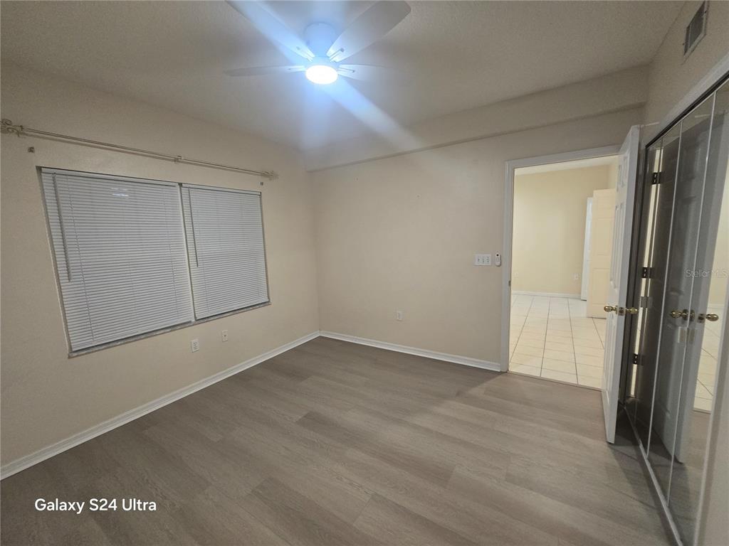 399 150th Avenue, Unit 218 Madeira Beach, FL 33708 - Photo 50 of 84 an empty room with wooden floor and closet