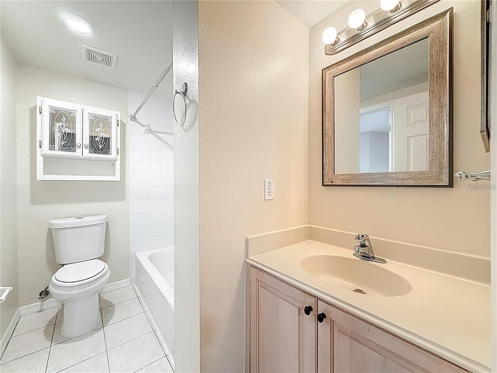399 150th Avenue, Unit 218 Madeira Beach, FL 33708 - Photo 52 of 84 a bathroom with a sink a toilet and a mirror