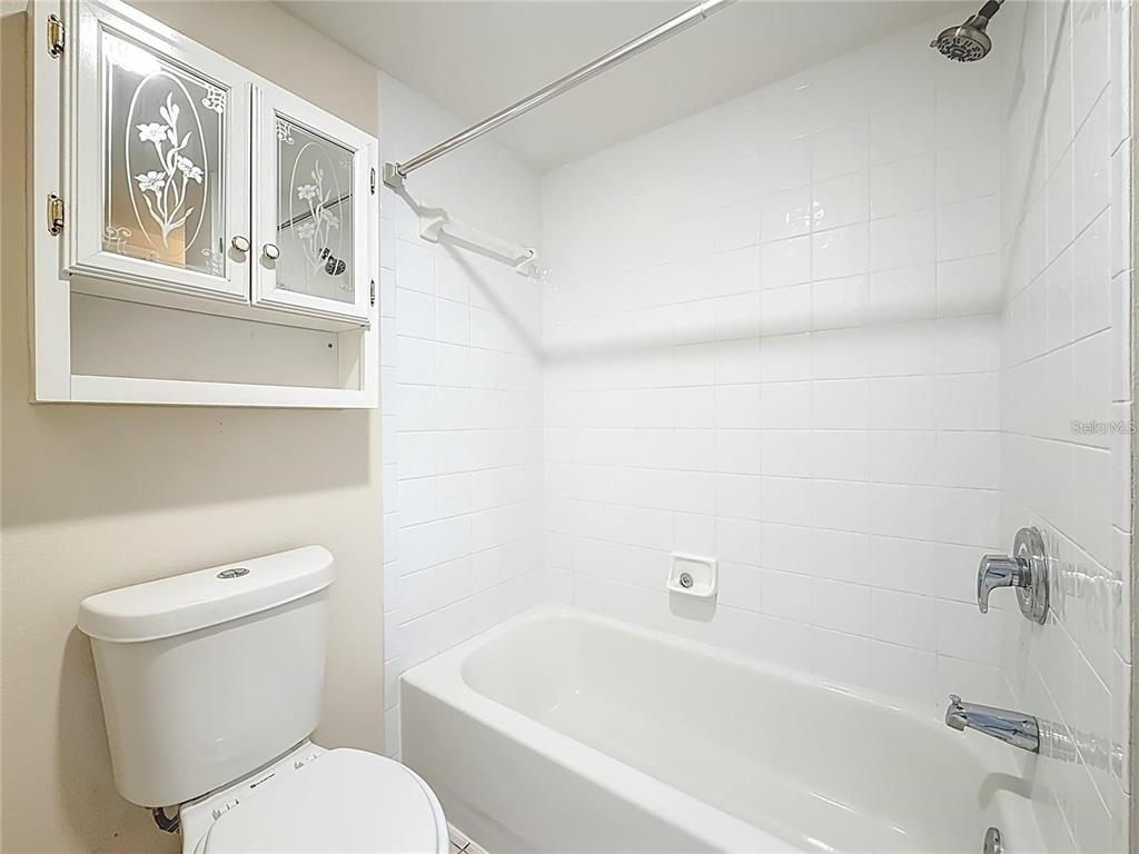 399 150th Avenue, Unit 218 Madeira Beach, FL 33708 - Photo 54 of 84 a white toilet sitting next to a bath tub