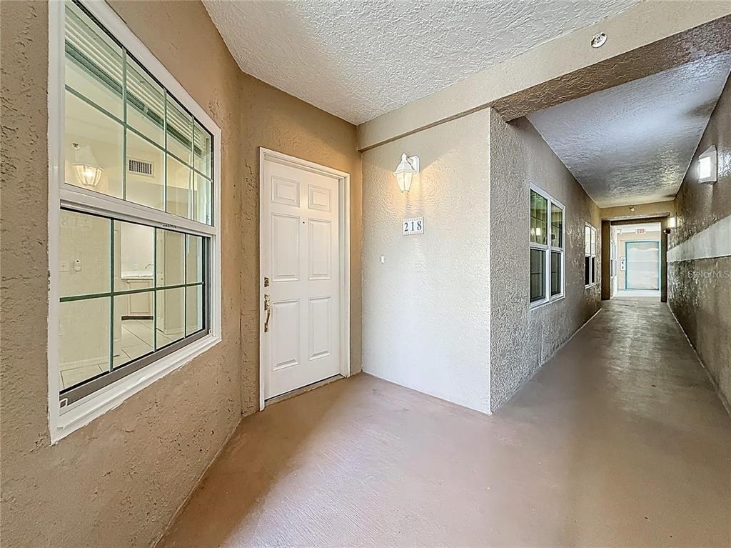 399 150th Avenue, Unit 218 Madeira Beach, FL 33708 - Photo 8 of 84 a view of a hallway with windows