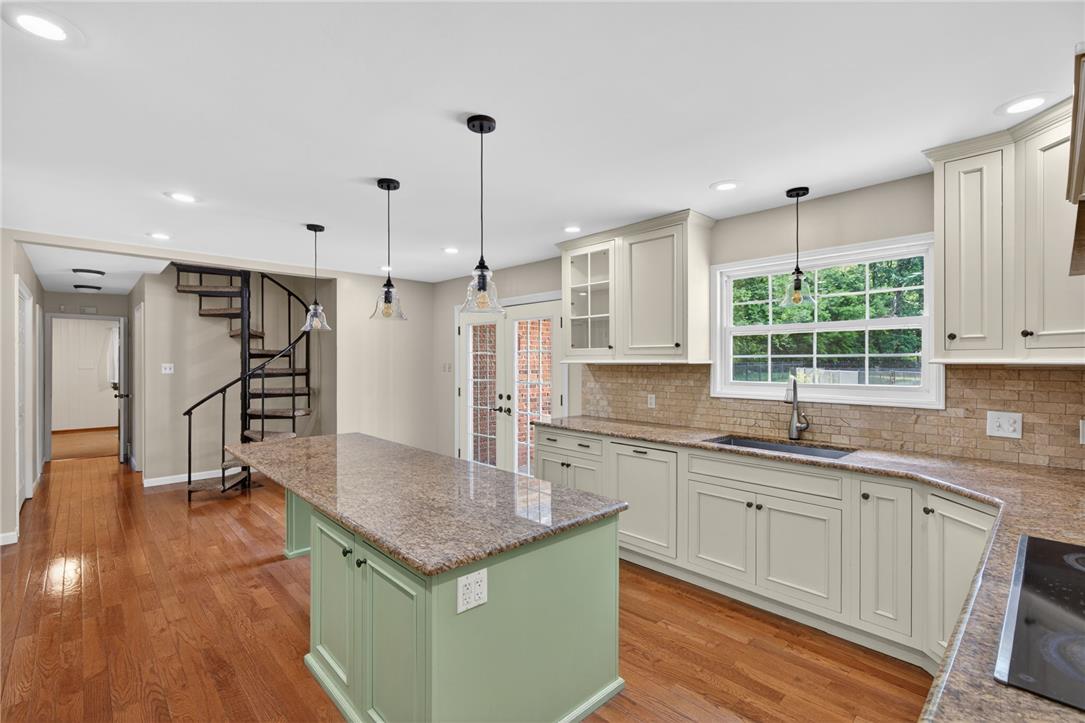1371 Stoke Park Road Bethlehem, PA 18017 - Photo 23 of 55 a kitchen with stainless steel appliances granite countertop a sink a stove and a wooden floors