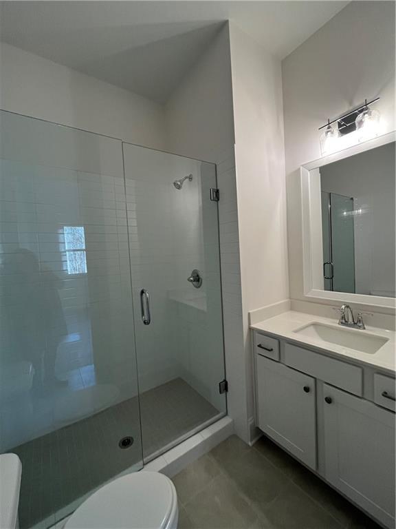 3745 Reserve Overlook Way Cumming, GA 30041 - Photo 15 of 87 a bathroom with a shower sink mirror and toilet