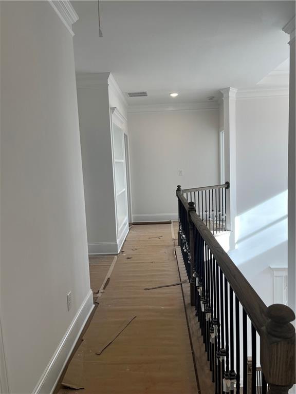 3745 Reserve Overlook Way Cumming, GA 30041 - Photo 45 of 87 a view of a hallway with wooden floor and staircase