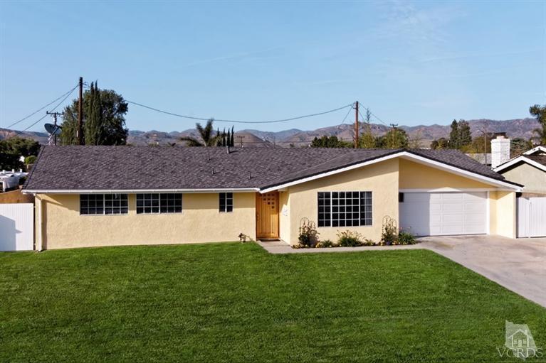 4553 Alpine Street Simi Valley, CA 93063 - Photo 1 of 25 a front view of a house with a yard and garage