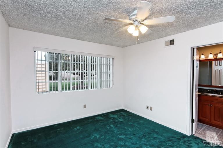 4553 Alpine Street Simi Valley, CA 93063 - Photo 14 of 25 an empty room with windows and ceiling fan