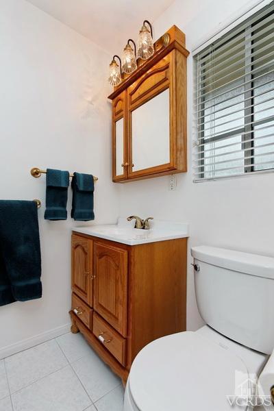 4553 Alpine Street Simi Valley, CA 93063 - Photo 16 of 25 a bathroom with a toilet sink and mirror