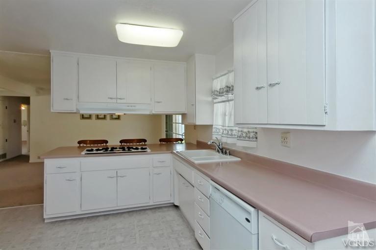 4553 Alpine Street Simi Valley, CA 93063 - Photo 5 of 25 a kitchen with a sink stove and cabinets