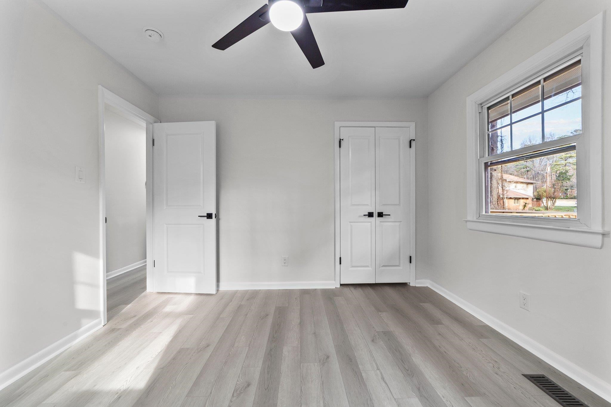 317 Wayne Circle Durham, NC 27707 - Photo 24 of 37 an empty room with wooden floor and windows