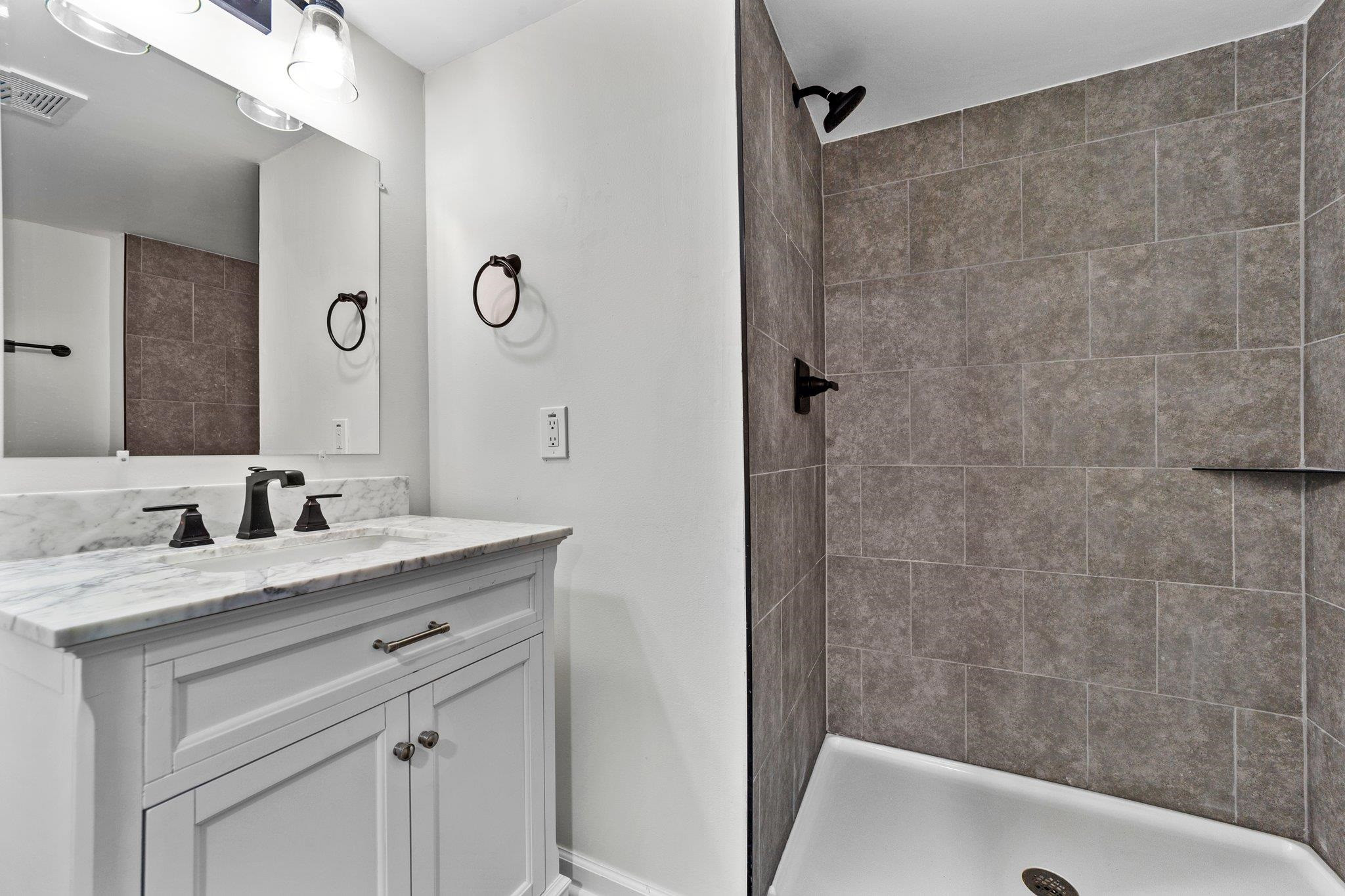 317 Wayne Circle Durham, NC 27707 - Photo 32 of 37 a bathroom with a granite countertop sink a toilet and shower